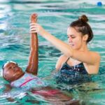 Swim instructor with her student in the pool